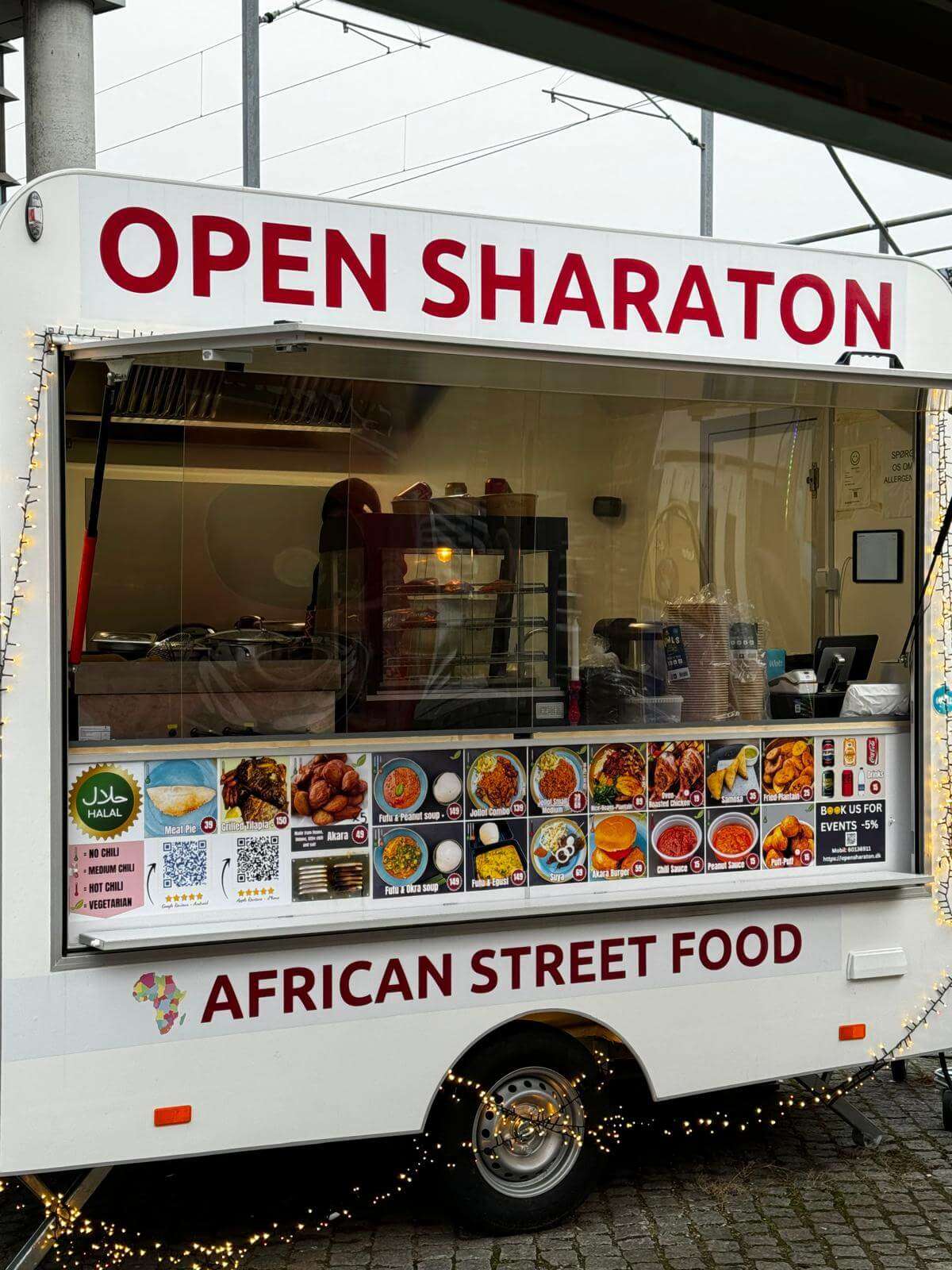 a food truck with lights and signs